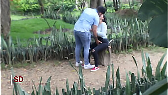 Secretly Observing A Young Couple Outdoors In A Public Park